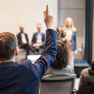Man raising hand in educational session