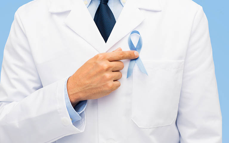DR pointing to blue Prostate Cancer Ribbon