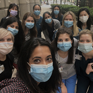 women wearing surgical masks poses for a selfie during a group walk