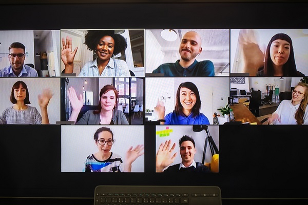 Screen shot of Zoom meeting with people waving to the camera