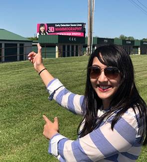 Amy K. Patel, MD, pointing to billboard with her photo on it